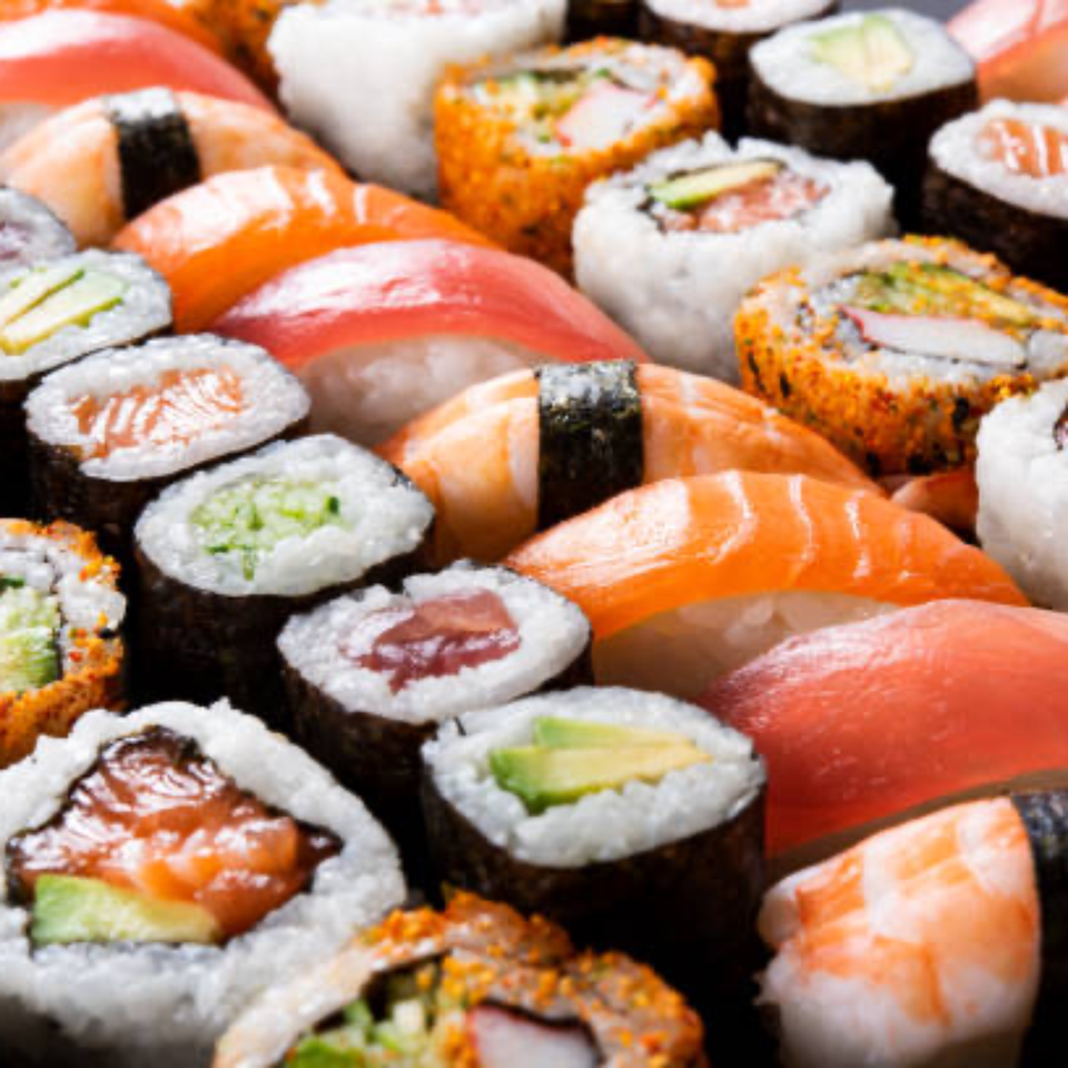 A vibrant assortment of sushi rolls and nigiri, showcasing various fish, rice, and vegetable fillings.
